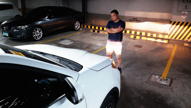 person standing in a parking spot to reserve it