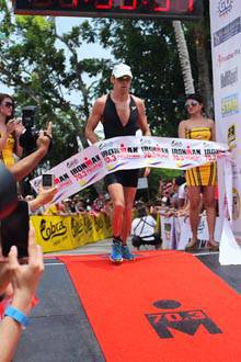 Jenson Button crosses the Cobra Ironman 70.3 finish line